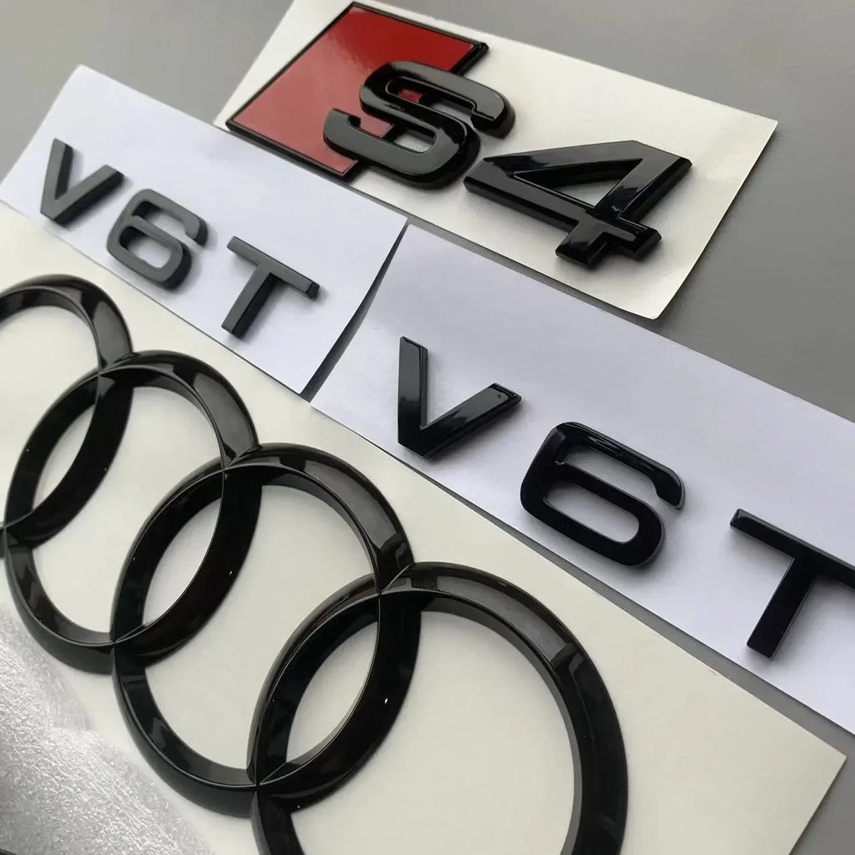 ABS 4-Ring Bright Black Car Hood Front Grill Emblem Rear Trunk Badge V6T Sticker Modified Accessories for Audi S4 2020-2024